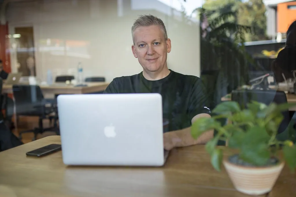 Stu Jordan at his laptop in a cafe